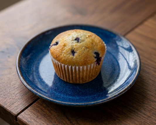 Smart choice Blueberry muffin on a blue plate on a wooden table